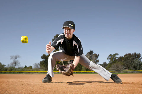 Bright yellow SKLZ reaction ball with black logo, three spheres clustered together on white background
