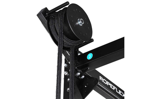 Black rope trainer with attached braided climbing rope and pulley system on white background