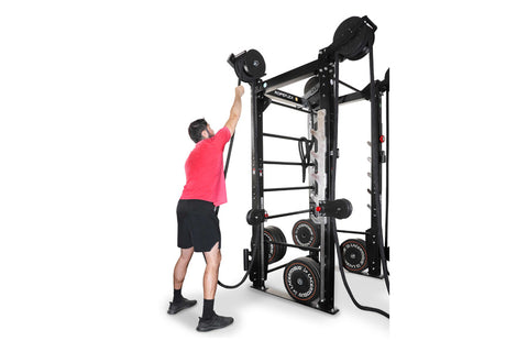 Black rope trainer with attached braided climbing rope and pulley system on white background