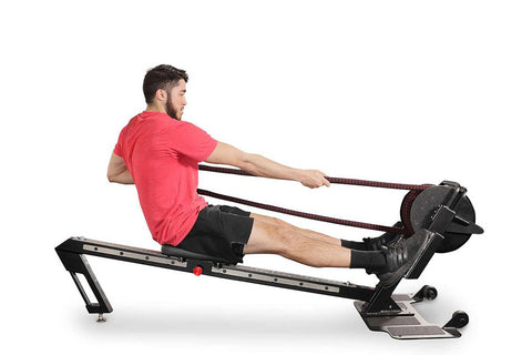 Man in red t-shirt and black shorts using black Ropeflex RX3200 rowing machine with rope handles on white background