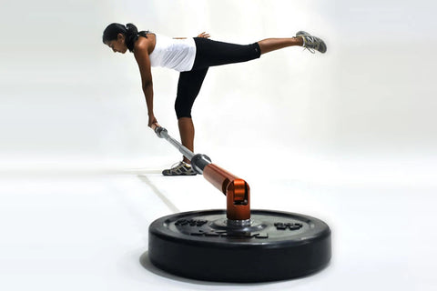 Athlete in white tank top and black leggings performing a plank exercise on Warrior Promotion Renegade Pro with extended leg,
