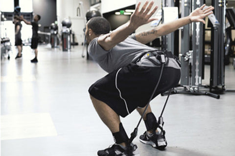 SKLZ Hopz training kit with black waist belt, two black ankle cuffs with yellow accents, gray and yellow resistance bands in 