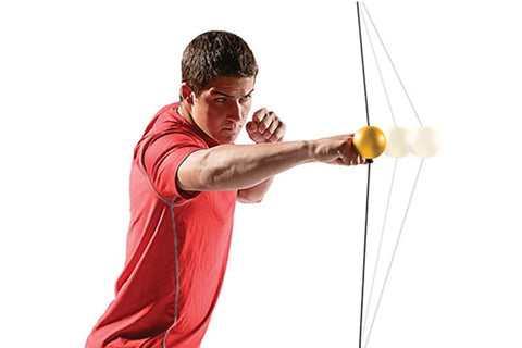 Man in red shirt aiming white compound bow with yellow target ball on white background