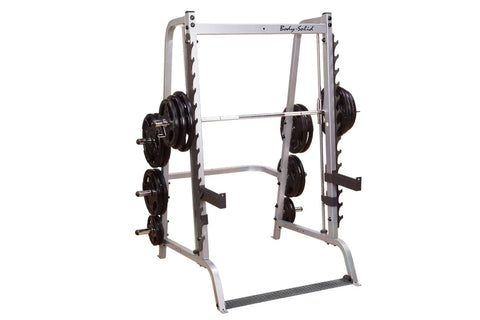 Body-Solid Series 7 Smith Machine with gray steel frame, black weight plates on side pegs, and barbell bar on white backgroun
