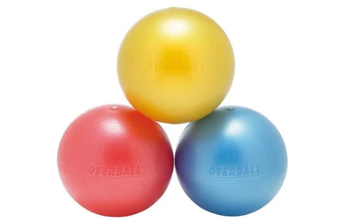 Three soft exercise balls stacked together in yellow, red, and blue with textured surfaces on white background