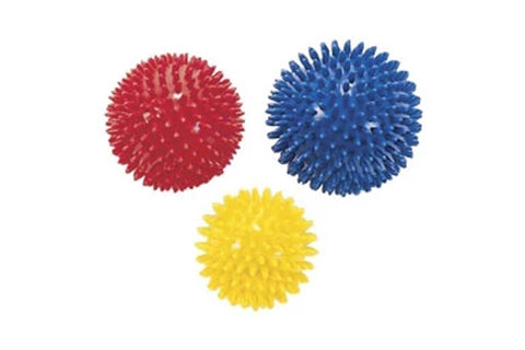 Three textured massage balls in red, blue, and yellow with spiky rubber nubs on white background