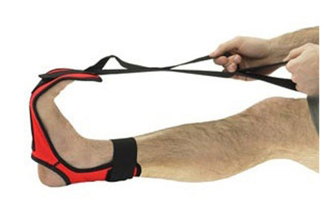 Red and black leg stretch strap with handle, worn by model on foot against white background