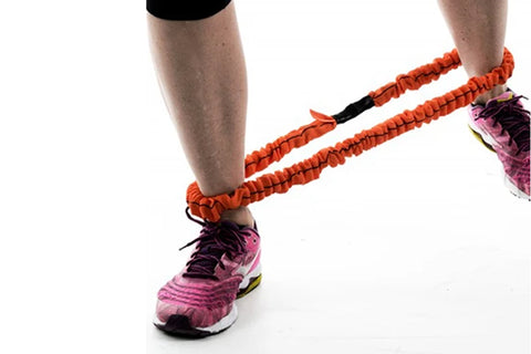 Warrior Stroops Slastix orange and black resistance training straps worn by model with purple athletic shoes