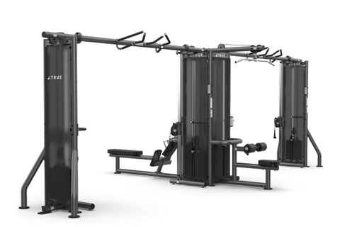 TRUE TMS6000 modular gym system with dual cable crossovers, black steel frame with adjustable arms and benches, on white back
