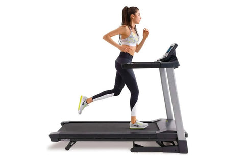 Woman running on black and gray LifeSpan TR2000i folding treadmill wearing white sports bra and black leggings