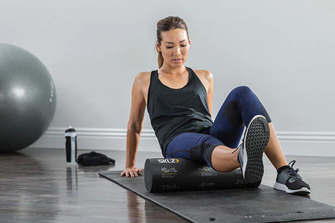 SKLZ black cylindrical foam roller with white instructional diagrams and yellow text on white background