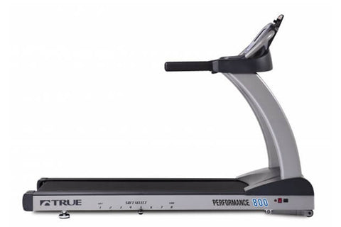 TRUE Performance 800 treadmill with black running deck, gray frame, digital display console, and cushioned handrails on white