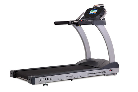 TRUE Performance 800 treadmill with black running deck, gray frame, digital display console, and cushioned handrails on white