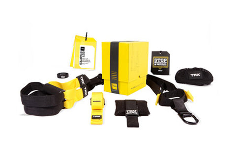 TRX Home Suspension Trainer system in yellow and black, including anchor strap, suspension straps, resistance bands, and acce
