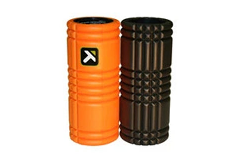 Two cylindrical foam rollers side by side, one bright orange with logo and one black with textured grid pattern