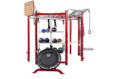Red and silver multi-station fitness trainer with rebounder trampoline, cable machine attachments, weight storage shelves hol