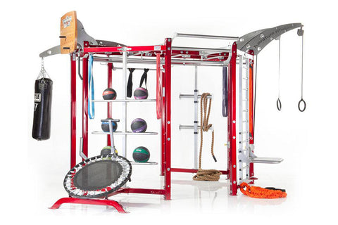 Red and silver multi-functional fitness training system with medicine ball storage, suspension rings, cable attachments, and 
