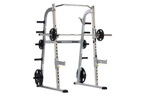 TuffStuff Evolution half cage with silver frame, black weight plates, and barbell on white background