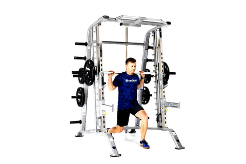 TuffStuff Evolution silver Smith machine with half cage combo, man in navy shirt performing squat with barbell, loaded weight