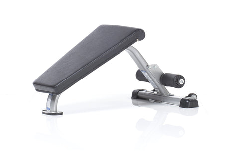 TuffStuff Mini Ab Bench with gray padded seat, silver metal frame, and black foot platform on white background