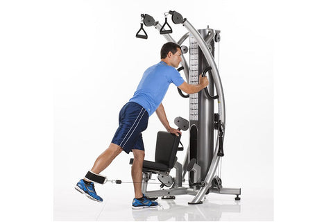 TuffStuff Six-Pak Functional Trainer silver and black multi-station gym equipment with cable pulleys and handles on white bac
