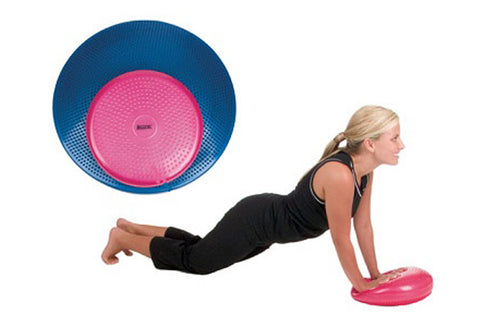 Pink and blue balance disc trainer, shown in flat lay view and worn during plank exercise by model in black workout attire