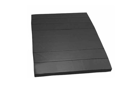 Black folding tumbling mat with horizontal seams, flat lay on white background