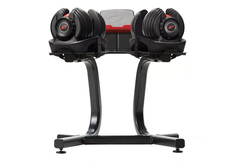 Bowflex SelectTech adjustable dumbbell stand with two black dumbbells and red accents on white background