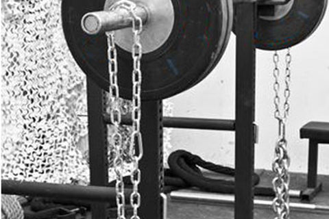 Warrior Chain Attachment Kit with metal chains and silver carabiners attached to black weight plate rack in gym setting