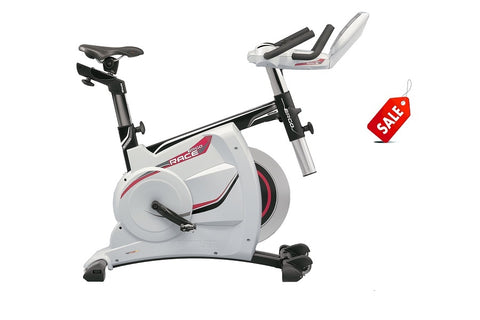 White and black stationary exercise bike with red accents, adjustable handlebars, and digital display, shown on white backgro