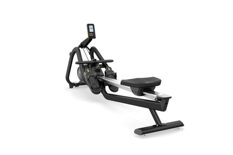 Black and silver Matrix rowing machine with digital console, footplate, and ergonomic handles on white background