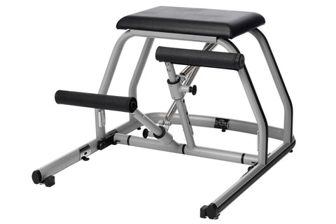 Peak Pilates MVe Chair with split pedal, silver metal frame, black padded seat and handles, on white background