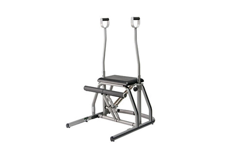 Peak Pilates MVe split pedal chair with gray metal frame, black seat and foot pedals, dual overhead handles on white backgrou
