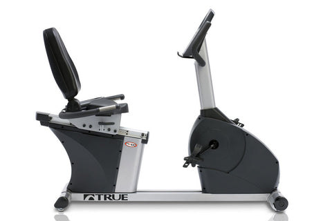 TRUE PS100 recumbent exercise bike with black padded seat and backrest, silver frame, and large black flywheel, shown on whit