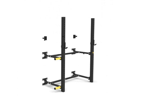 Black and yellow wall-mounted squat rack with dual vertical posts, adjustable arms, and safety spotter positions on white bac