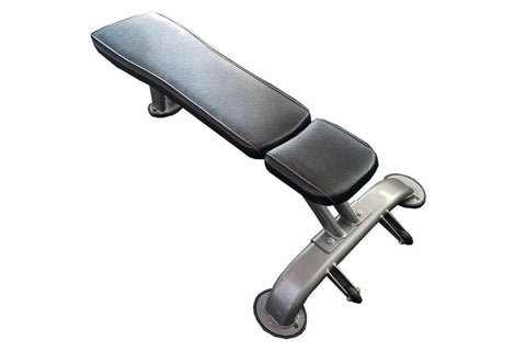 Black padded flat weight bench with adjustable headrest and sturdy metal frame on white background