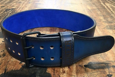 Gray leather weightlifting belt with red suede interior, metal buckle, and ventilation holes on white background