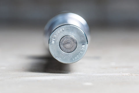 York Women's Elite Competition Olympic Bar with silver finish and yellow stripe band on concrete surface