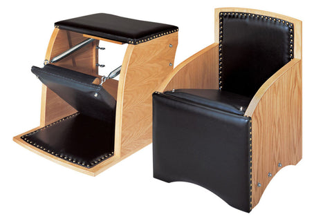 Wood and black leather Pilates Wunda Chair with nailhead trim, shown from front and side angles with footrest extended
